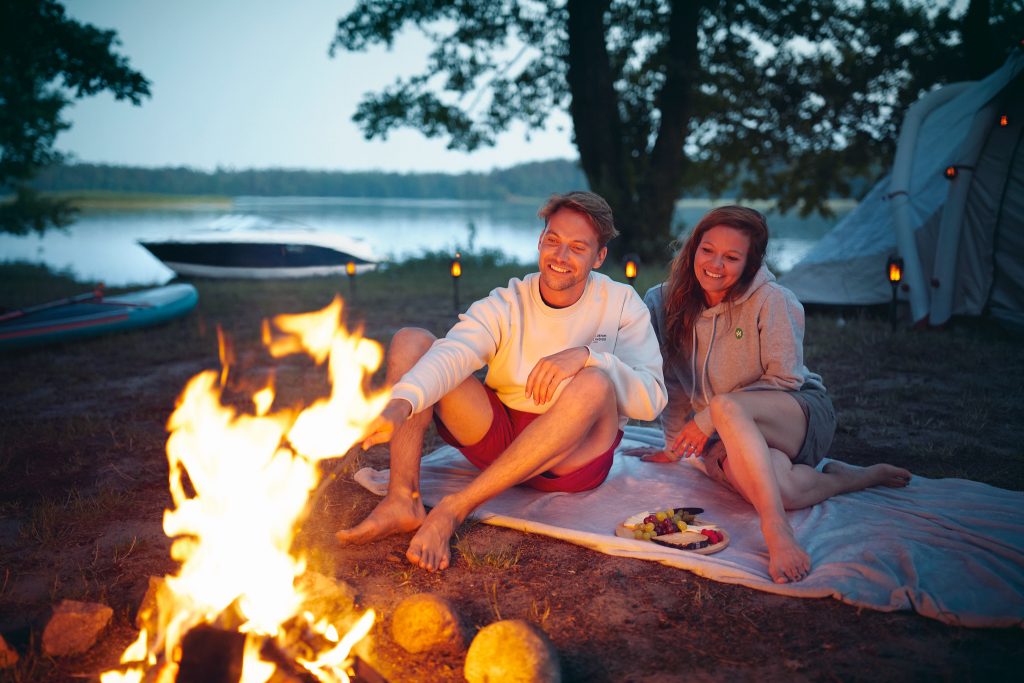 Couple at a campsite next to an SPX 190 at twilight