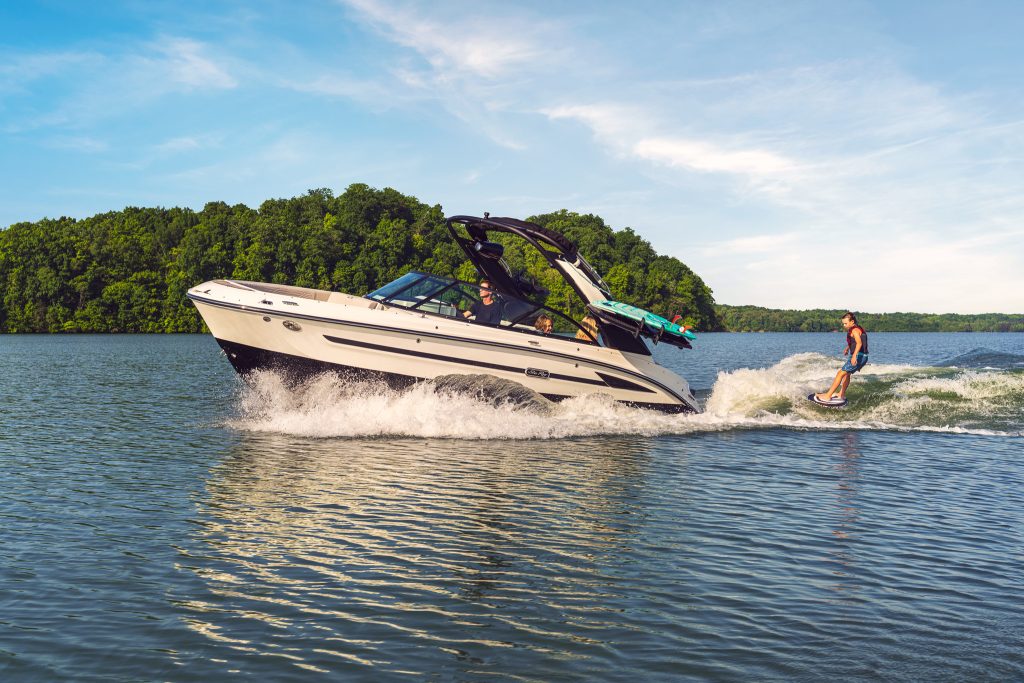 Kid wakesurfing behind an SDX 230 Surf