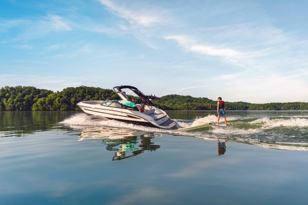 Kid wakesurfing behind an SDX 230 Surf
