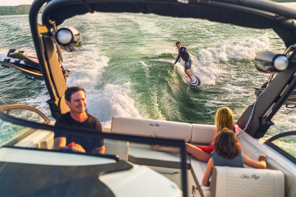 Kid wakesurfing behind an SDX 230 Surf