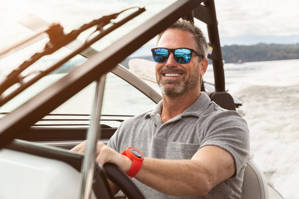 Man at the helm of an SLX 260 Surf