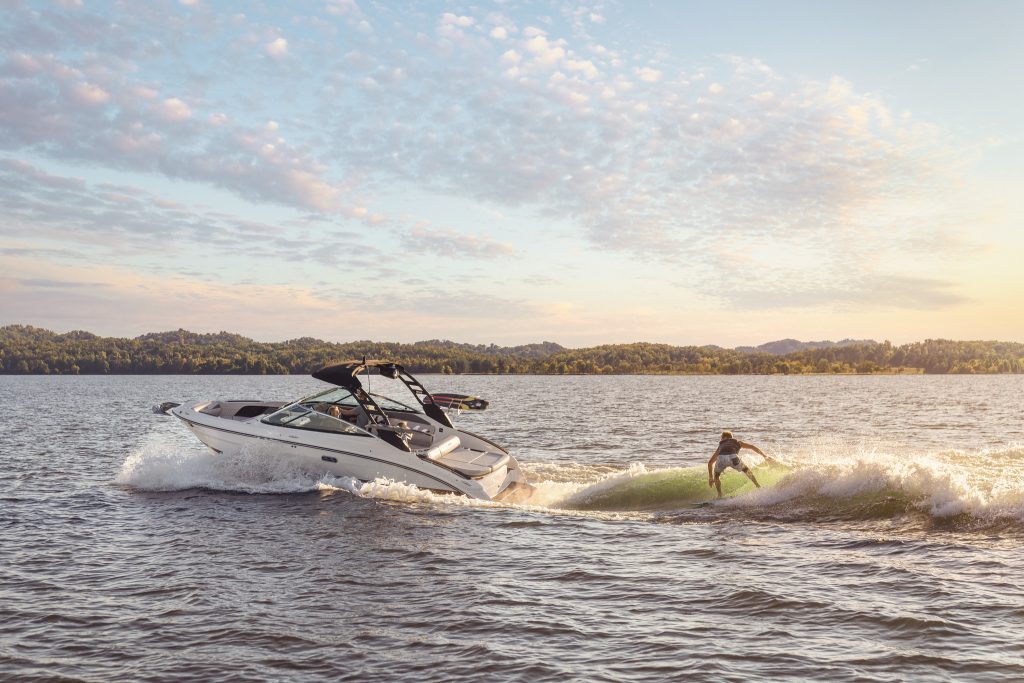 Man wakesurfing behind an SLX 260 Surf