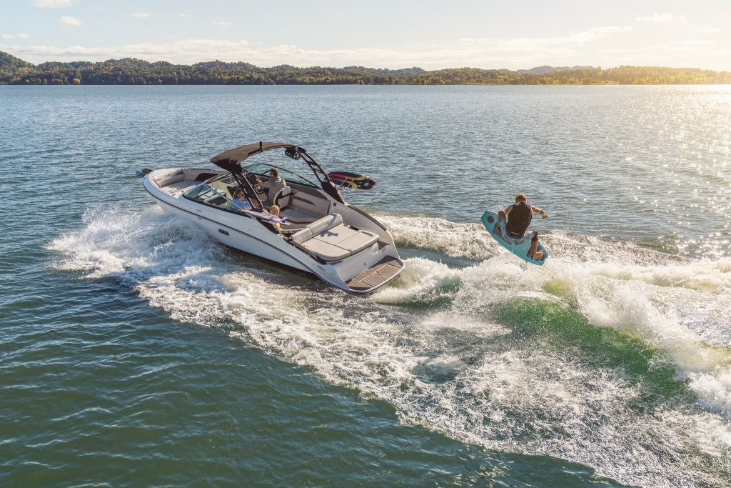 Man wakesurfing behind an SLX 260 Surf