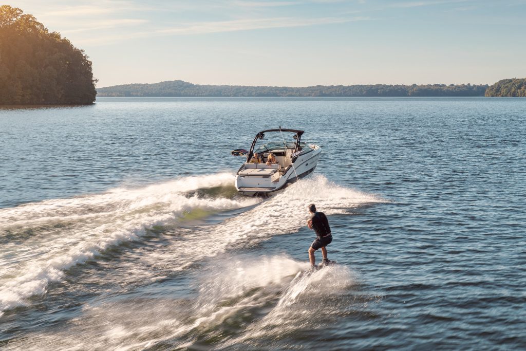 Man wakeboarding behind an SLX 260 Surf
