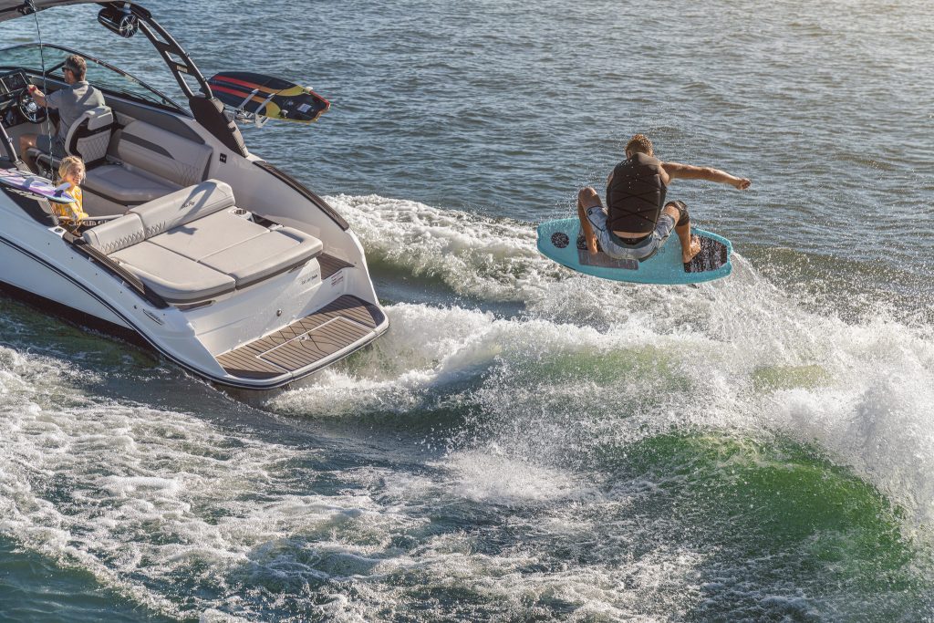 Man wakesurfing behind an SLX 260 Surf