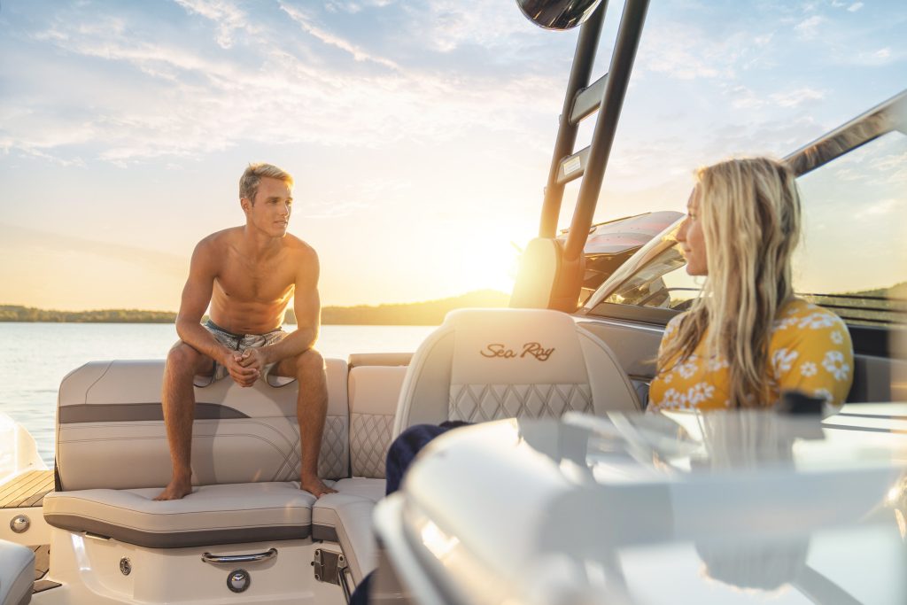 Brother and sister aboard an SLX 260 Surf at sunset