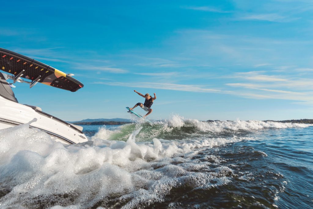 Man wakesurfing behind an SLX 260 Surf