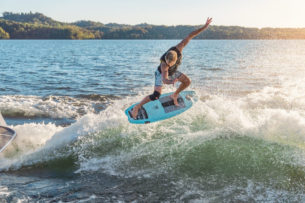 Man wakesurfing behind an SLX 260 Surf