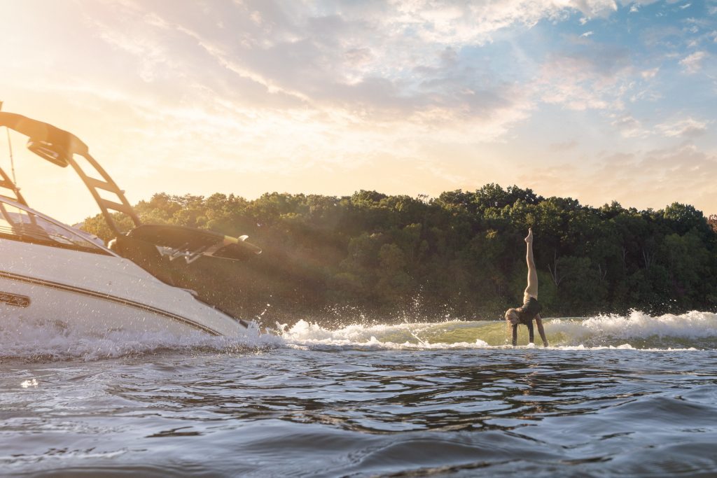Woman wakesurfing behind an SLX 260 Surf