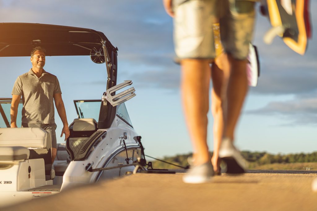 Family boarding an SLX 260 Surf