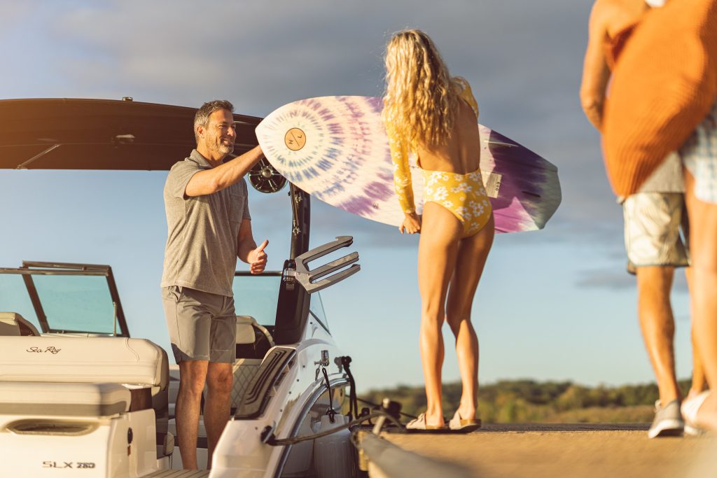 Family boarding an SLX 260 Surf