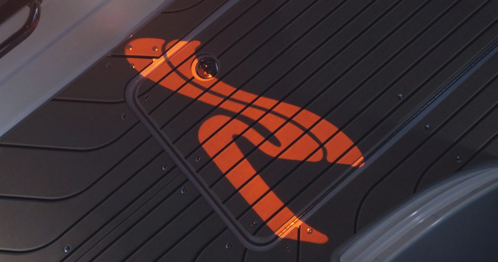 Sea Ray logo light projected onto the cockpit floor of an SLX 260 Surf