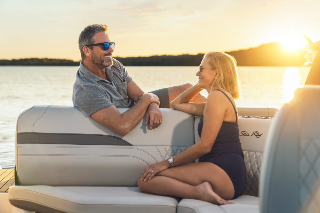Couple aboard an SLX 260 Surf at sunset