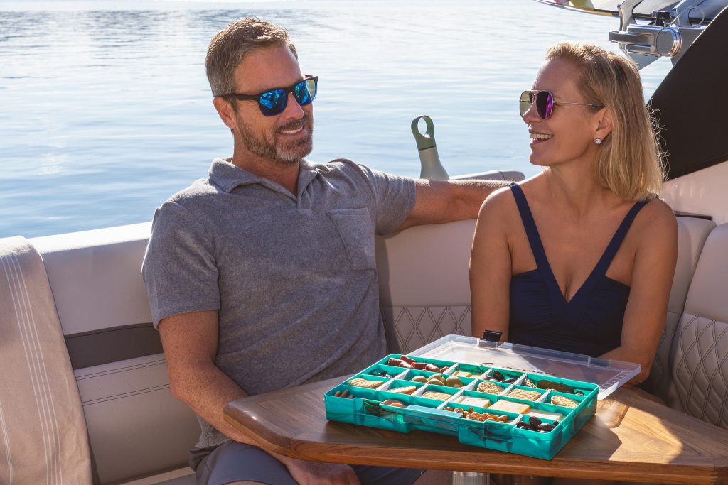 Couple sitting at the cockpit table on an SLX 260 Surf