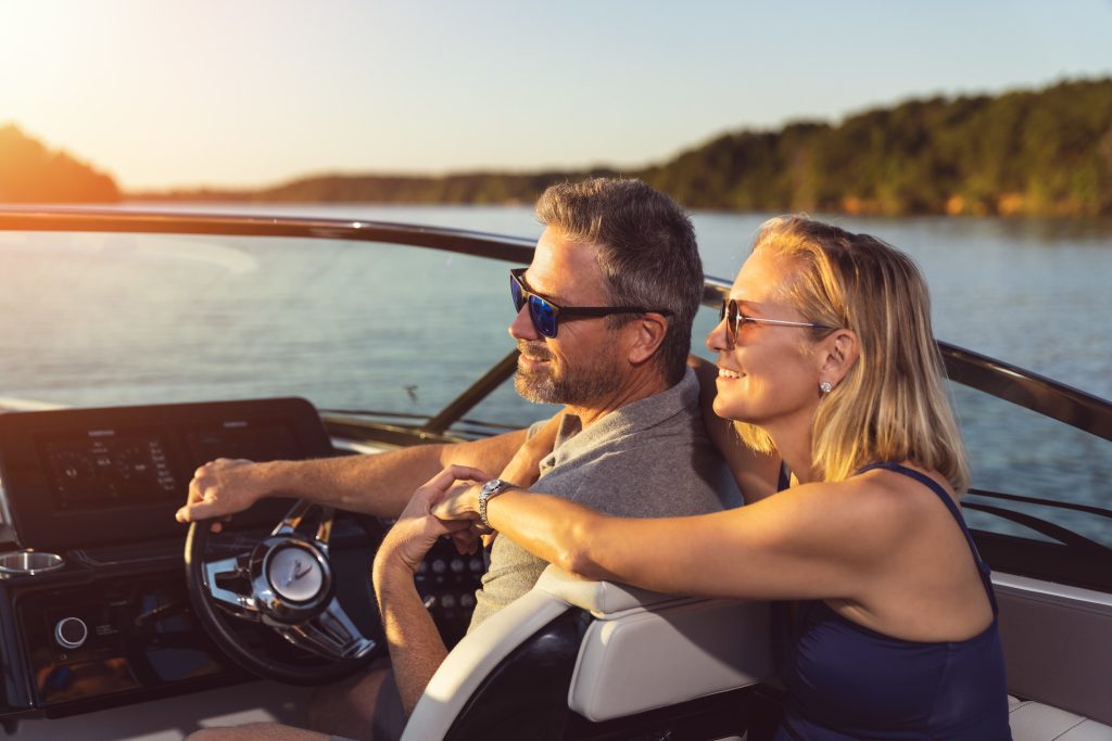 Couple at the helm of an SLX 260 Surf