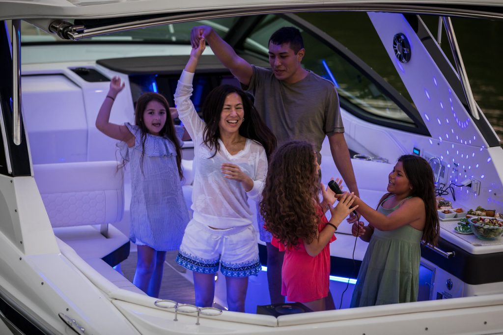 Family enjoying a fun evening aboard a Sundancer 320
