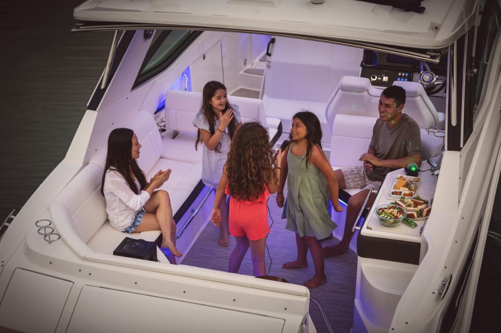 Family enjoying a fun evening aboard a Sundancer 320