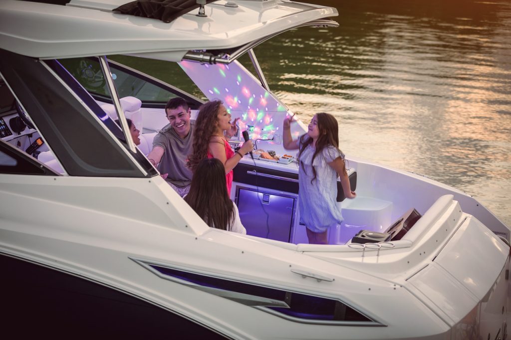 Family enjoying a fun evening aboard a Sundancer 320