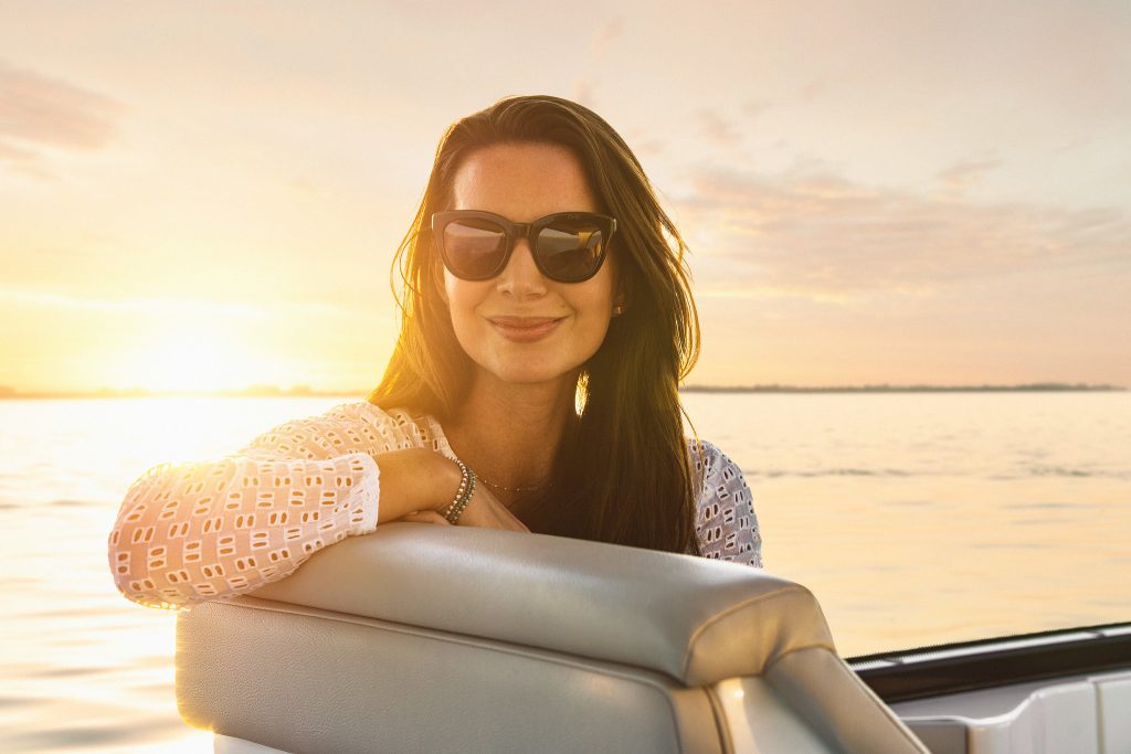 Woman with sunglasses aboard a Sundancer 370 Outboard